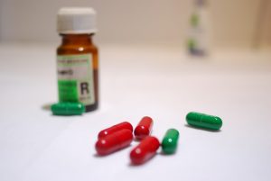 red and green capsules of prescription medication